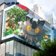 A 3D billboard for Pokemon GO, with Galarian Meowth seeing to reach out of the screen.